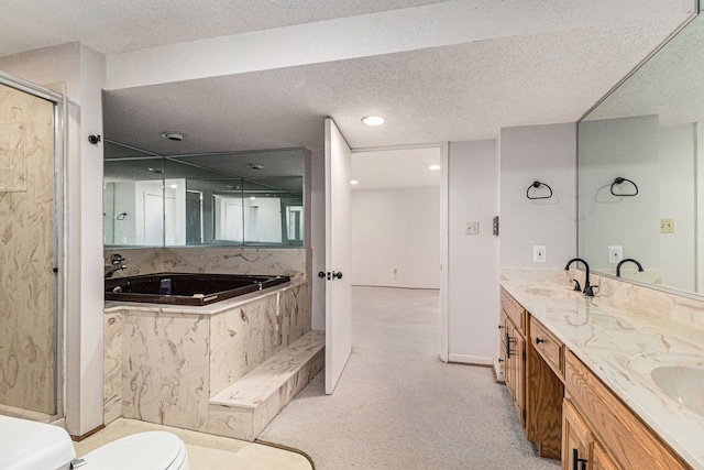 bathroom with a textured ceiling, a shower with shower door, a sink, a bath, and double vanity