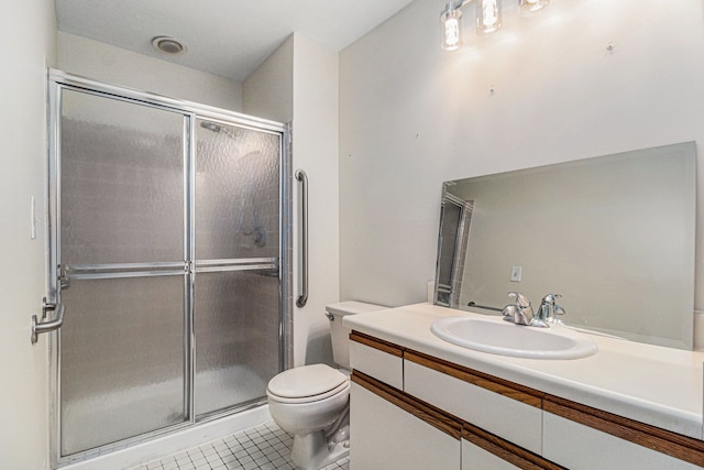 bathroom with toilet, a shower stall, vanity, and tile patterned floors