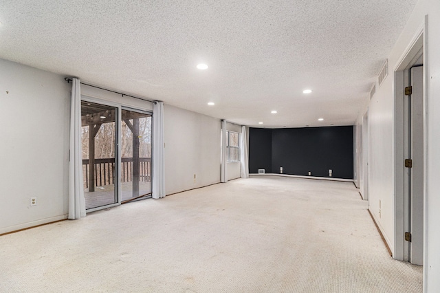 empty room with visible vents, baseboards, a textured ceiling, carpet flooring, and recessed lighting