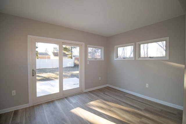 interior space with wood finished floors and baseboards