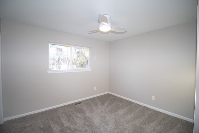 unfurnished room with a ceiling fan, carpet, visible vents, and baseboards