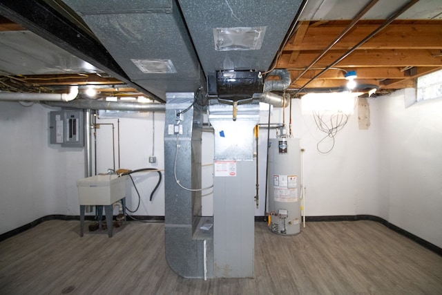 unfinished basement with wood finished floors, gas water heater, a sink, and electric panel