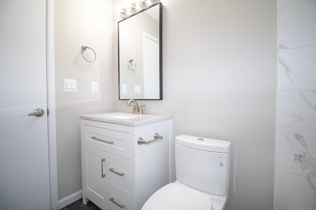 bathroom featuring toilet and vanity