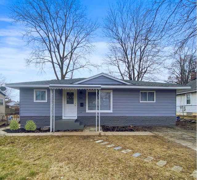 view of front of property with a front yard and fence