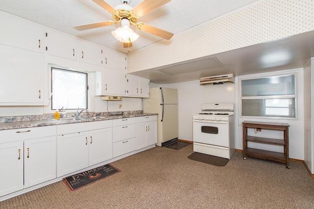 kitchen featuring white cabinets, a sink, ceiling fan, white appliances, and under cabinet range hood