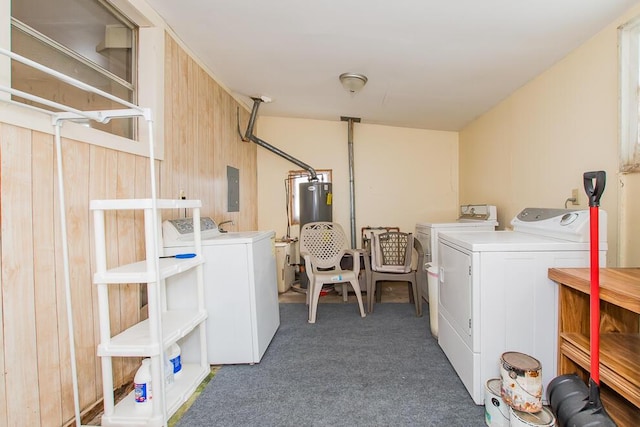 laundry room featuring washing machine and clothes dryer, water heater, carpet flooring, laundry area, and electric panel