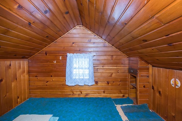 unfurnished bedroom featuring lofted ceiling, wooden ceiling, wooden walls, and a sauna