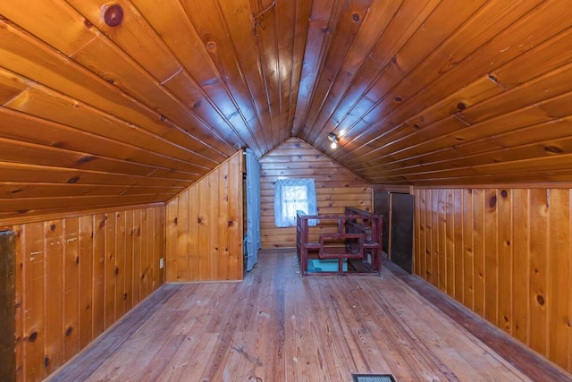 bonus room featuring vaulted ceiling, hardwood / wood-style floors, wood walls, and wood ceiling