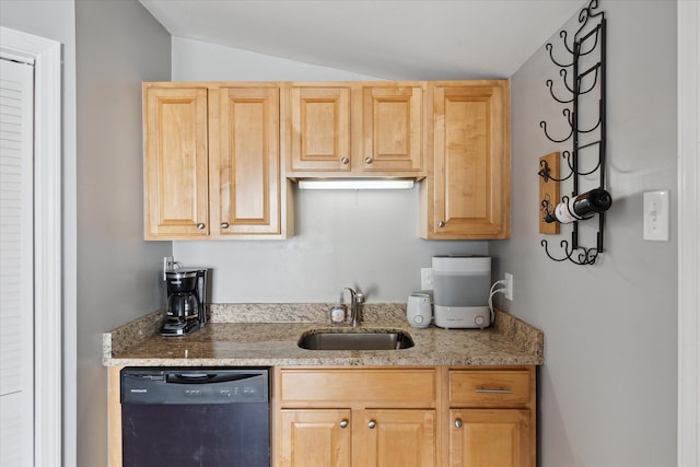 kitchen with vaulted ceiling, black dishwasher, light brown cabinets, and a sink