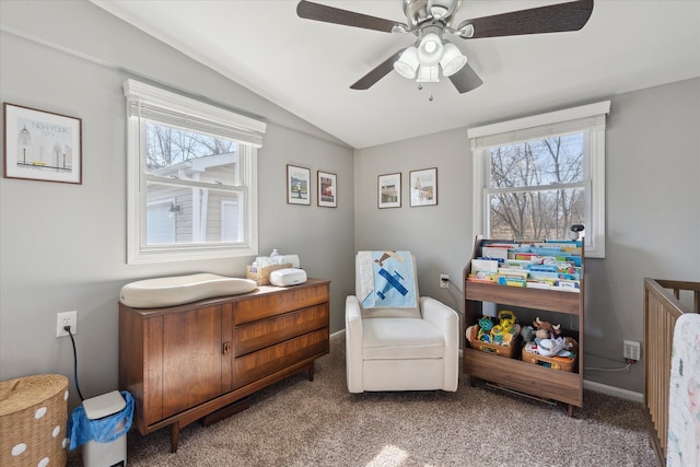 sitting room with vaulted ceiling, carpet, baseboards, and ceiling fan