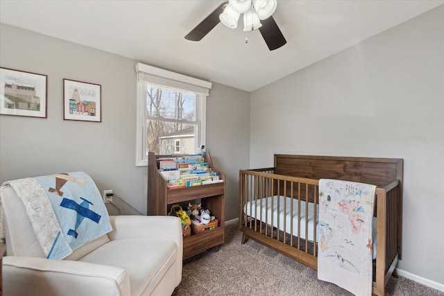 bedroom with a crib, baseboards, ceiling fan, vaulted ceiling, and carpet floors