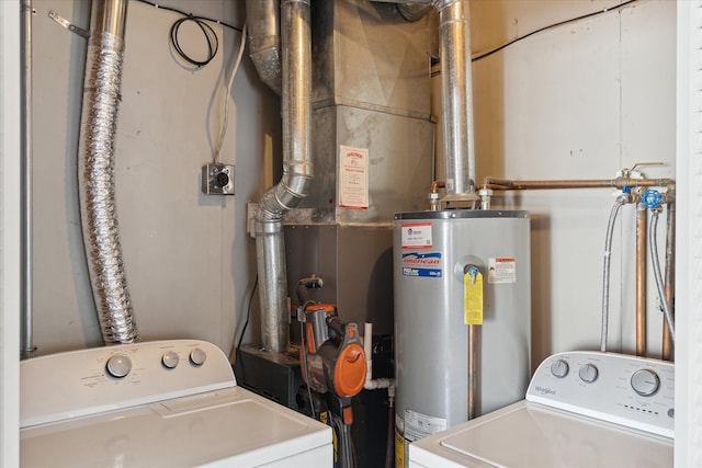 clothes washing area with independent washer and dryer, water heater, and laundry area