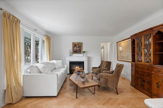 living room featuring visible vents, baseboards, and a glass covered fireplace