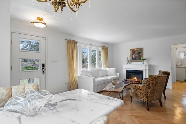 bedroom featuring a glass covered fireplace and baseboards