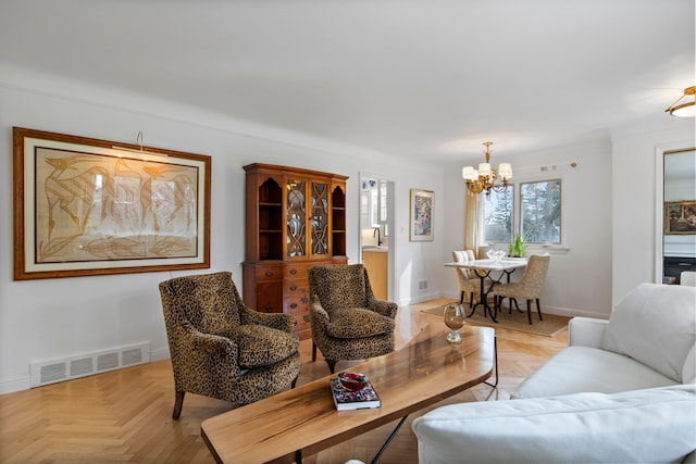 living room featuring an inviting chandelier, baseboards, and visible vents