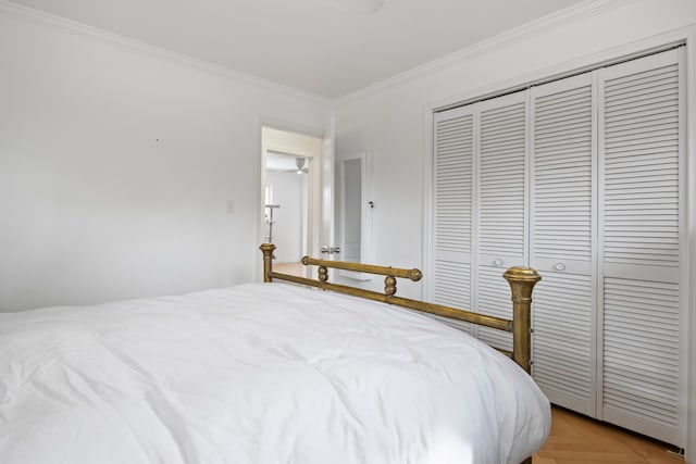 bedroom featuring a closet and crown molding