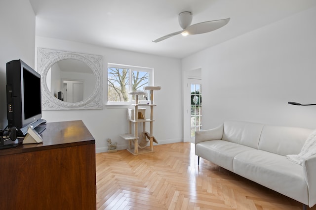 office space with ceiling fan and baseboards