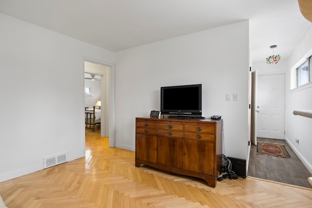 interior space featuring baseboards and visible vents