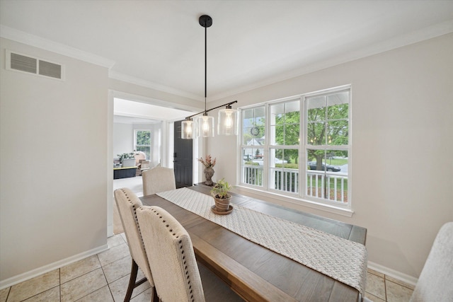 dining room featuring baseboards, visible vents, crown molding, and light tile patterned flooring