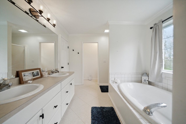 full bath featuring double vanity, ornamental molding, a sink, and a bath