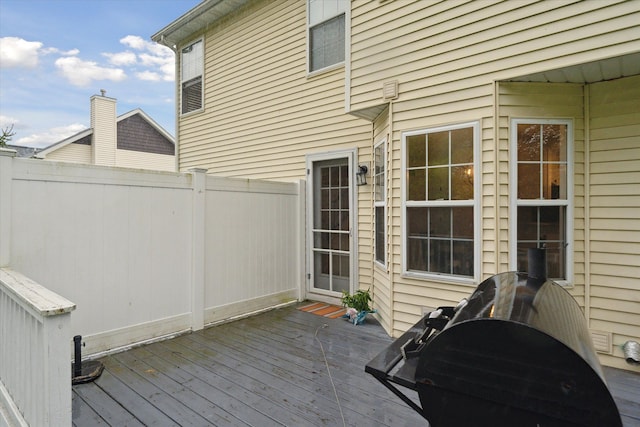 wooden deck featuring fence and area for grilling