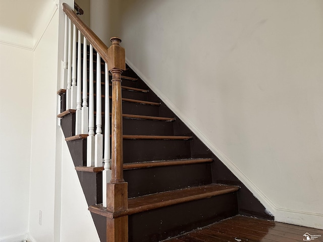 staircase featuring wood finished floors