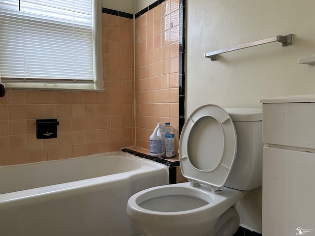 bathroom with a bath and toilet