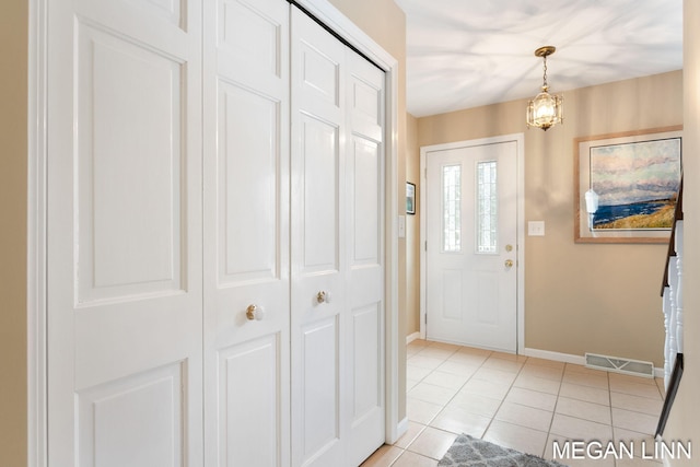 entryway with visible vents, baseboards, and light tile patterned floors