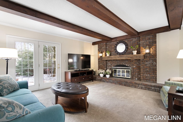 living room featuring beamed ceiling, carpet, and a brick fireplace