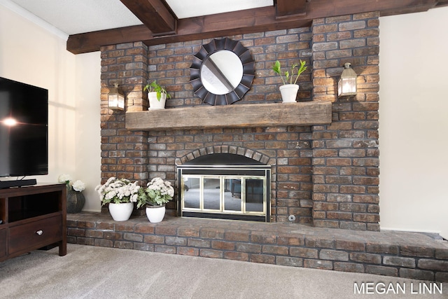 living area featuring carpet, a brick fireplace, and beamed ceiling