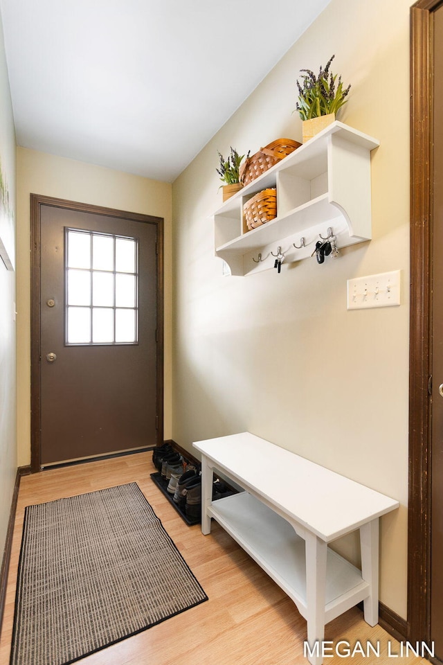 mudroom featuring baseboards and light wood finished floors