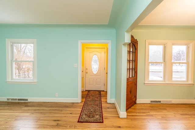 entrance foyer featuring light wood-style flooring, visible vents, and baseboards