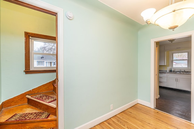 stairway with baseboards and wood finished floors