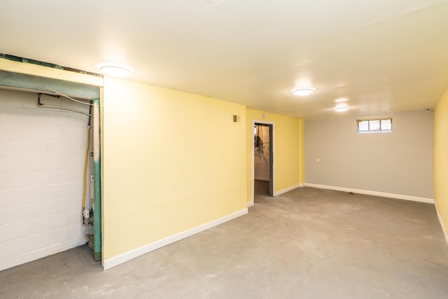 basement with concrete block wall and baseboards