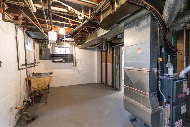 basement featuring electric panel and heating unit