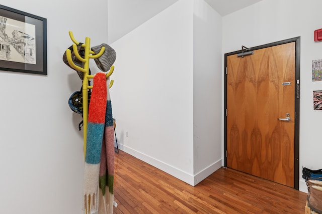 hall featuring baseboards and wood finished floors