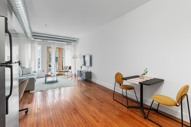 interior space featuring baseboards and hardwood / wood-style floors