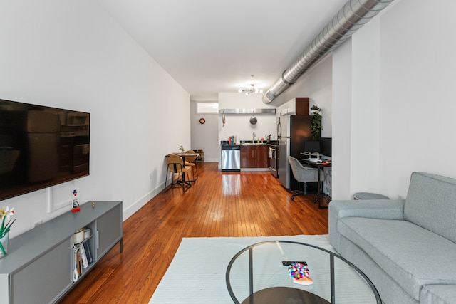 living room with light wood-style flooring and baseboards