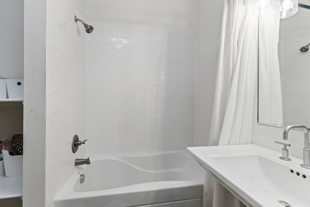 full bath with shower / bath combination with curtain and a sink