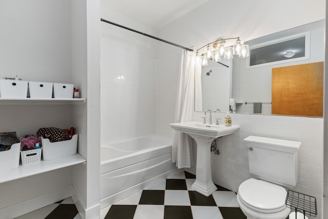 full bathroom featuring tile patterned floors, toilet, tile walls, and shower / tub combo