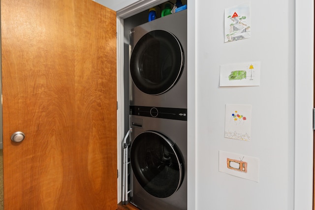 laundry room with stacked washer / dryer and laundry area