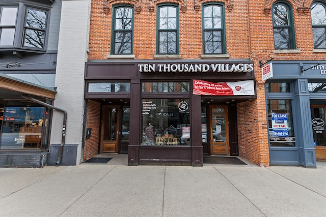 view of exterior entry featuring brick siding