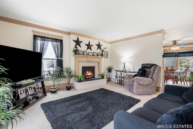 carpeted living room featuring ornamental molding, a brick fireplace, ceiling fan, and baseboards