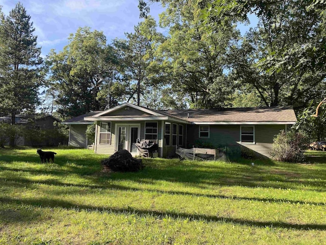 view of front of house featuring french doors and a front lawn