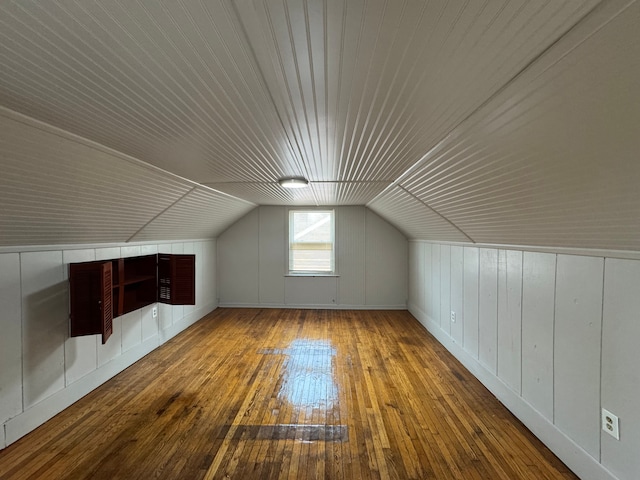 bonus room featuring vaulted ceiling and hardwood / wood-style floors