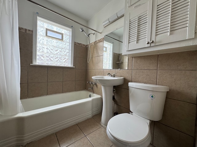 bathroom featuring a healthy amount of sunlight, tile patterned flooring, shower / bathtub combination with curtain, and toilet