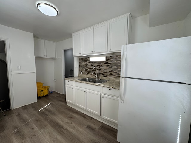 kitchen featuring white cabinetry, dark wood-type flooring, a sink, and freestanding refrigerator