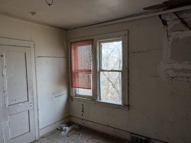 unfurnished room featuring visible vents