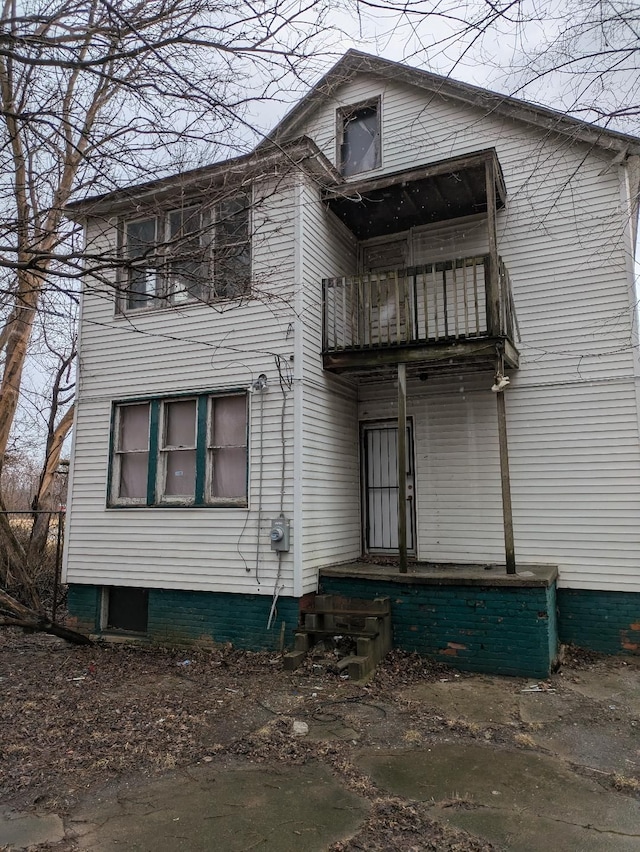 back of property featuring a balcony