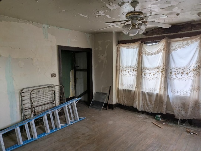 unfurnished room featuring a ceiling fan and wood finished floors